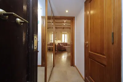 a hallway with a door leading to a living room at MM Trevi Apartment in Rome
