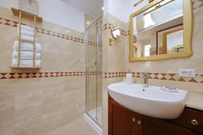 a bathroom with a sink and a shower at MM Trevi Apartment in Rome