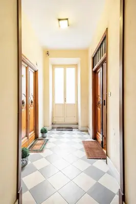 an empty hallway with a door and a tile floor at Nido degli Artisti in Trastevere Piazza Trilussa in Rome