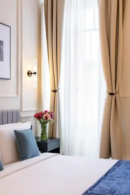 a bedroom with a bed and a vase of flowers at Piazza del Popolo Boutique GuestHouse in Rome