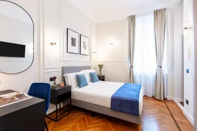 a hotel room with a bed and a mirror at Piazza del Popolo Boutique GuestHouse in Rome