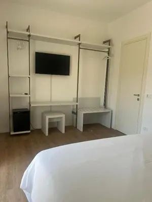 a bedroom with a bed and a flat screen tv at Toto San Paolo Rooms in Rome