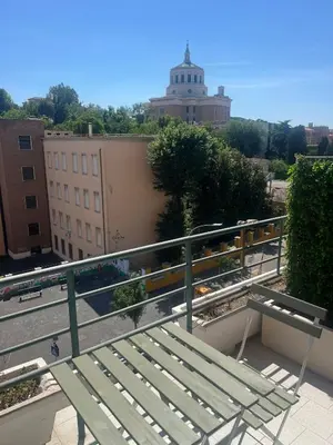 a green bench sitting on top of a building at Toto San Paolo Rooms in Rome