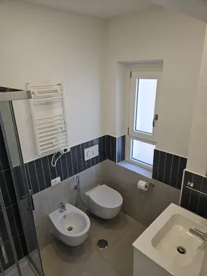 a bathroom with a toilet and a sink at Toto San Paolo Rooms in Rome