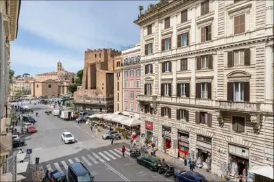 a view of a city street with cars and buildings at Sweet Home Colosseum in Rome