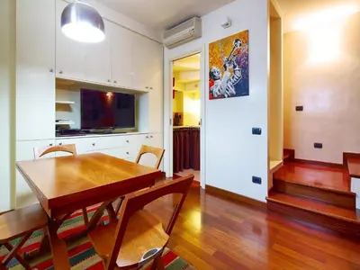 a kitchen and dining room with a wooden table at Sweet Home Colosseum in Rome