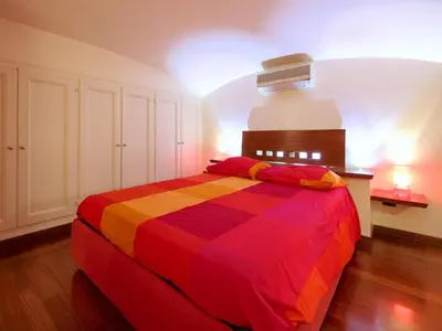 a bedroom with a colorful bed in a room at Sweet Home Colosseum in Rome