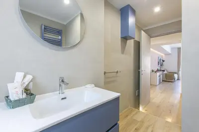 a bathroom with a white sink and a mirror at Roma Vaticano Deluxe in Rome