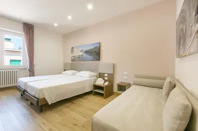 a hotel room with a bed and a couch at Roma Vaticano Deluxe in Rome