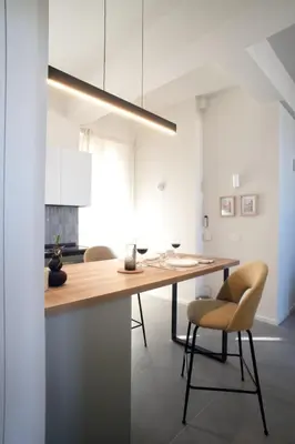 a kitchen with a wooden table and chairs at Beautiful Penthouse Roma in Rome