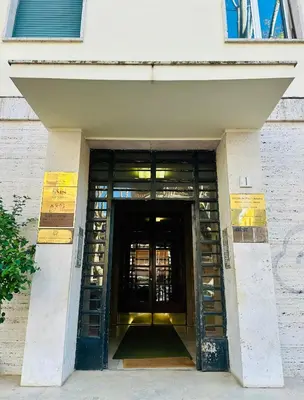 a hallway leading to a building with a door at Beautiful Penthouse Roma in Rome