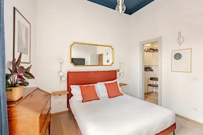 a bedroom with a bed and a mirror on the wall at Unique Piazza Navona 2 Bedrooms and Home Cinema in Rome
