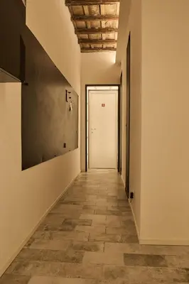 an empty hallway with a white door and a tile floor at BellaRoma NAVONA Guest house in Rome