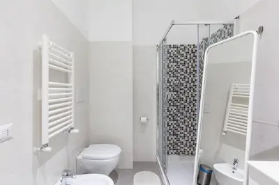 a white bathroom with a toilet and a shower at Alloggi Costantini - Ospedale Gemelli - Metro Battistini in Rome
