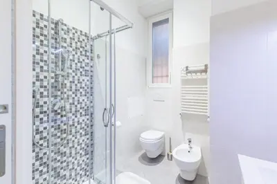 a white bathroom with a toilet and a shower at Alloggi Costantini - Ospedale Gemelli - Metro Battistini in Rome