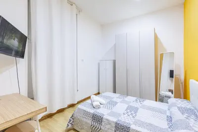 a small room with a bed and a tv at Alloggi Costantini - Ospedale Gemelli - Metro Battistini in Rome