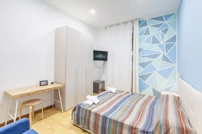 a bedroom with a bed and a desk and a window at Alloggi Costantini - Ospedale Gemelli - Metro Battistini in Rome