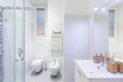 a white bathroom with a toilet and a shower at Alloggi Costantini - Ospedale Gemelli - Metro Battistini in Rome