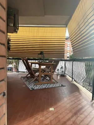 a picnic table on the balcony of a building at Silvestri206 in Rome