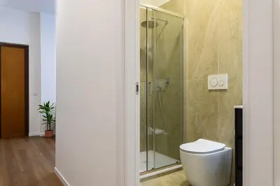 a bathroom with a toilet and a sink and a shower at Civico7 - Luxury Apartment in Rome