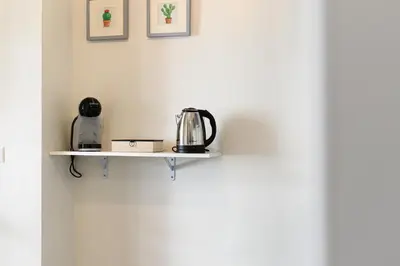 a couch sitting in a living room with a plant at Civico7 - Luxury Apartment in Rome