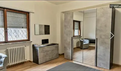a room with a glass door with a desk and a chair at Mother House in Rome