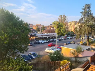 a city street with cars parked in a parking lot at Mother House in Rome