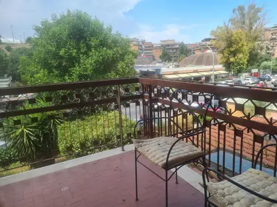 a chair on a balcony with a view of a city at Mother House in Rome