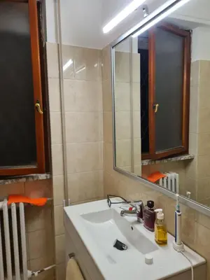 a bathroom with a white sink and a mirror at Mother House in Rome