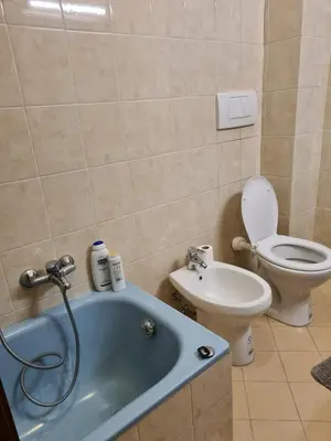 a bathroom with a tub and a toilet and a sink at Mother House in Rome