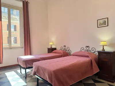 a room with two beds and a window at Casa Angeli 2 in Rome