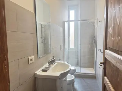 a bathroom with a sink and a toilet and a shower at Casa Angeli 2 in Rome
