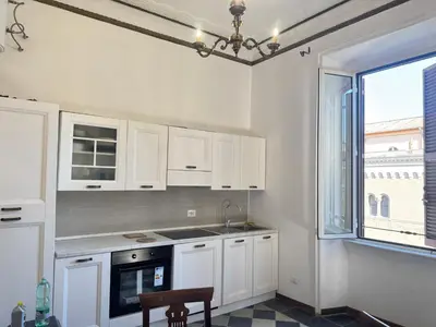 a kitchen with white cabinets and a sink and a window at Casa Angeli 2 in Rome