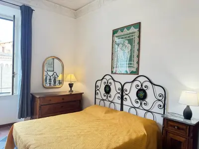 a bedroom with a bed and a picture on the wall at Casa Angeli 2 in Rome