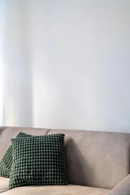 a green pillow sitting on top of a couch at Vatican Dimora Apartments in Rome