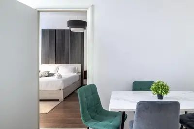a bedroom with a bed and a table and chairs at Vatican Dimora Apartments in Rome
