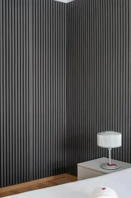 a white lamp on a table in front of a wall at Vatican Dimora Apartments in Rome