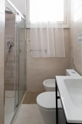 a bathroom with a toilet and a sink and a shower at Vatican Dimora Apartments in Rome