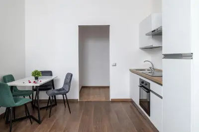 a kitchen and dining room with a table and chairs at Vatican Dimora Apartments in Rome
