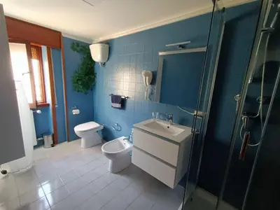 a bathroom with a toilet and a sink and a shower at Attico GianLuce in Rome