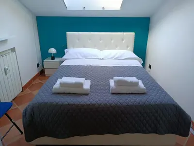 a bedroom with a large bed with two pillows on it at Attico GianLuce in Rome