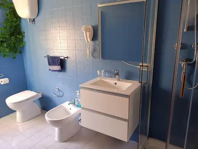 a bathroom with a toilet and a sink and a shower at Attico GianLuce in Rome