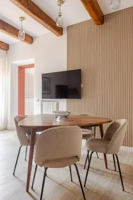 a dining room with a wooden table and chairs at Piazza di Spagna 2 Bedrooms and 5 Juliet Balcony in Rome