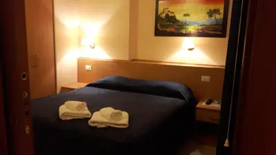 a hotel room with two towels on a bed at Palma in Rome