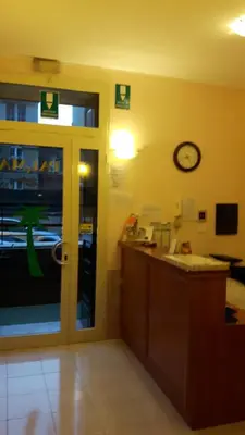 a office with a door and a clock on the wall at Palma in Rome