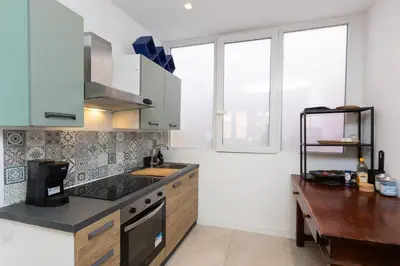 a kitchen with white cabinets and a table and windows at Casa Donna Olimpia Pamphilj in Rome