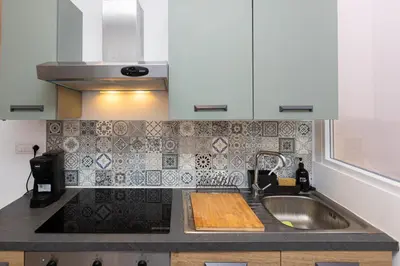 a kitchen sink with a wooden cutting board on it at Casa Donna Olimpia Pamphilj in Rome