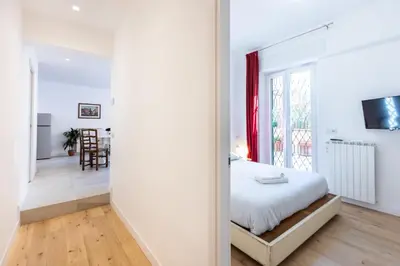 a bedroom with a bed and a large window at Casa Donna Olimpia Pamphilj in Rome