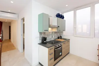 a kitchen with white walls and a counter top at Casa Donna Olimpia Pamphilj in Rome