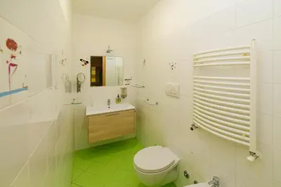 a white bathroom with a toilet and a sink at Casa Di Camilla in Rome